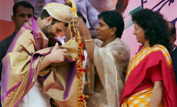Congress Vice President Rahul Gandhi being felicitated by women party workers at a public rally in Tumkur, in Karnataka on Sunday - PTI Congress Vice President Rahul Gandhi being felicitated by women party workers at a public rally in Tumkur, in Karnataka on Sunday - PTI